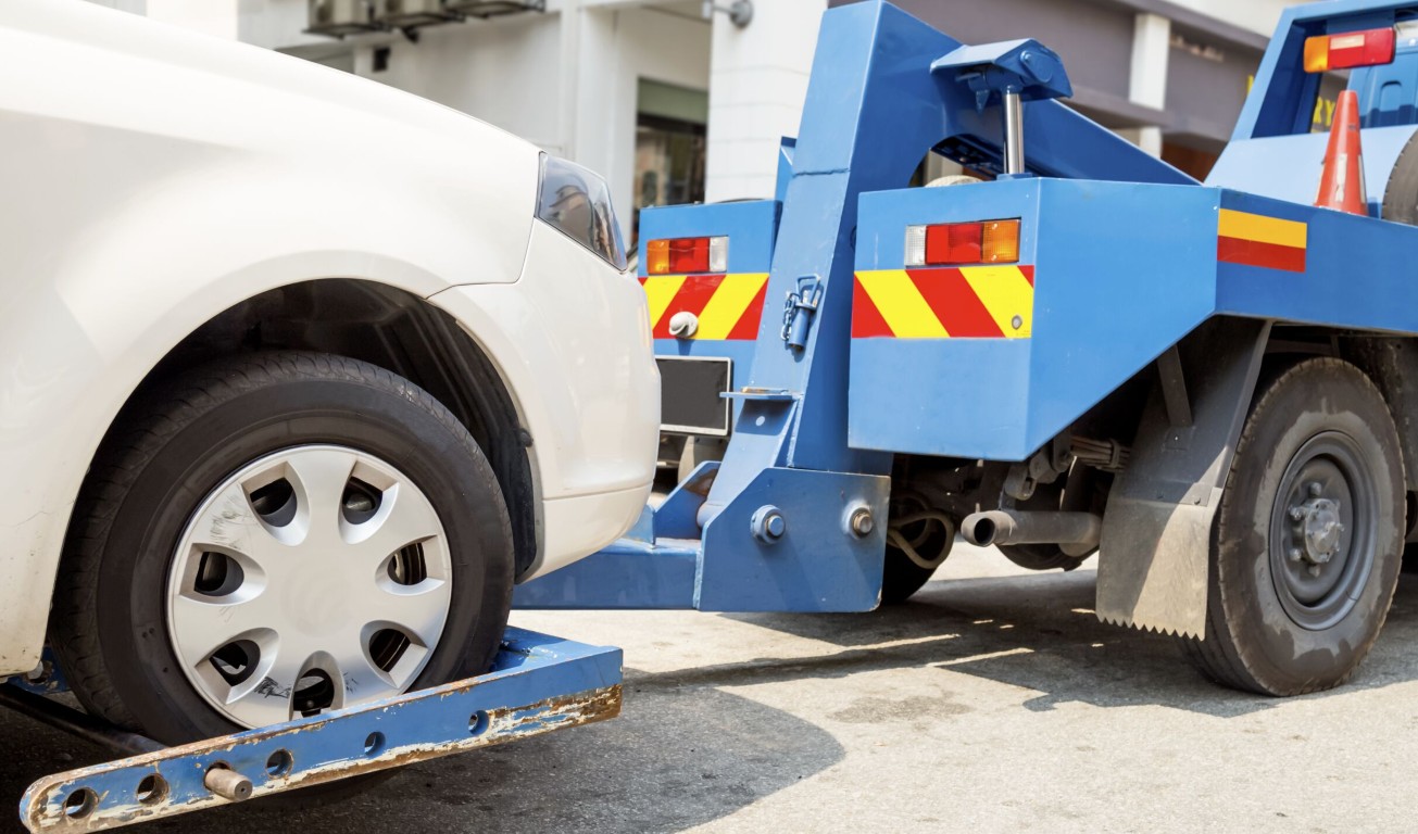 Tow truck operator assisting a car lockout situation in Encinitas, CA